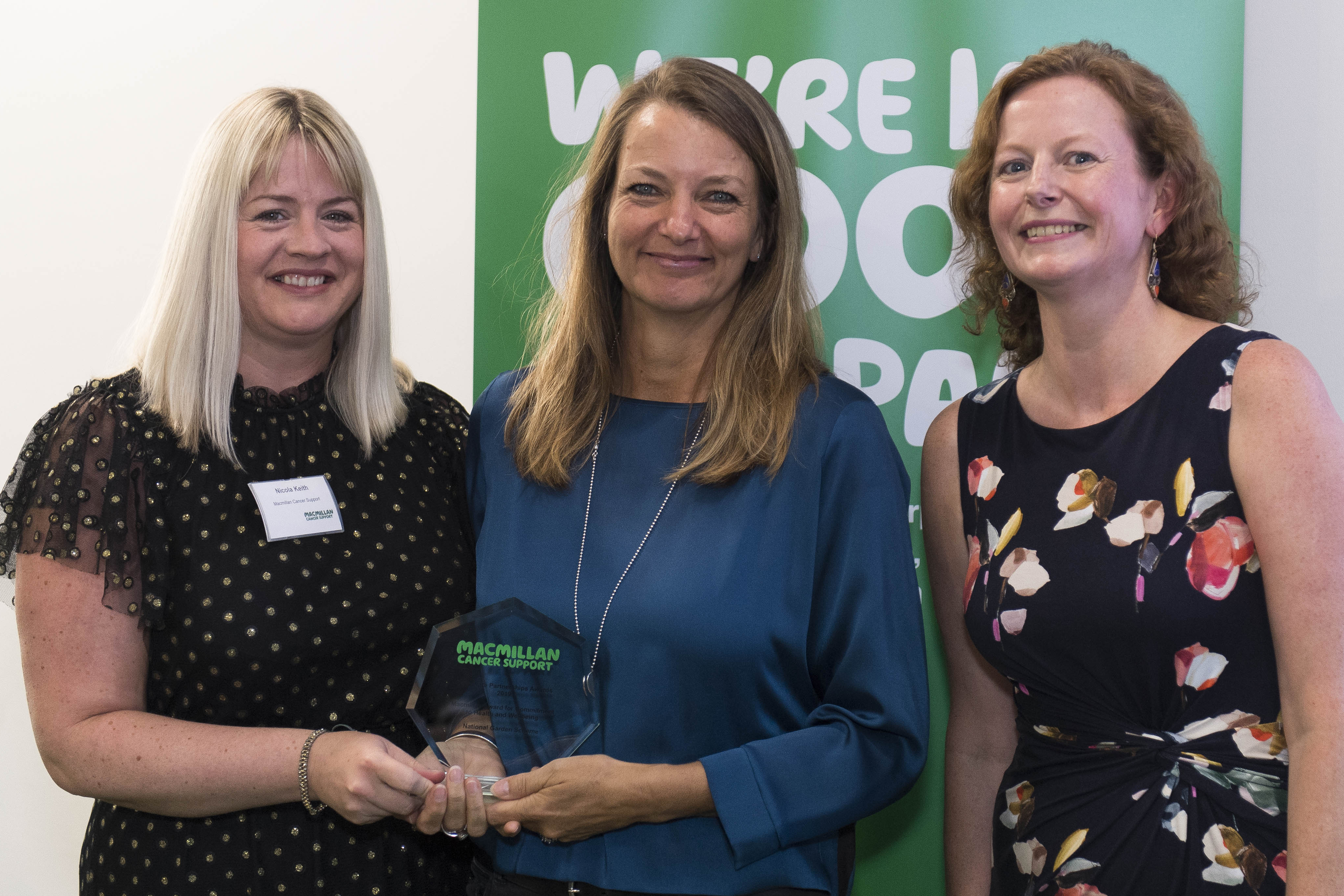 Macmillan Cancer Support's Nicola Keith (left) and Natasha Parker (right) present the award for Commitment to Health and Wellbeing to Vicky Flynn