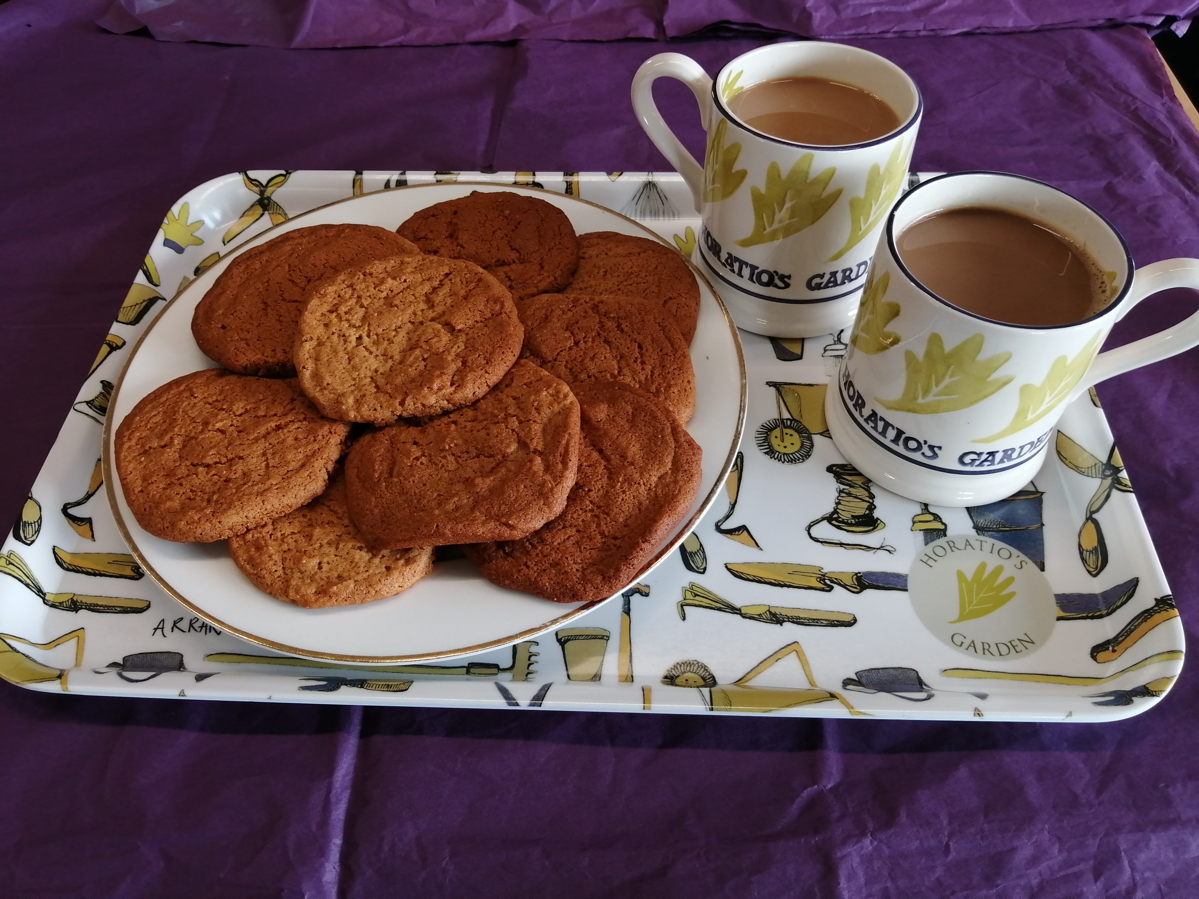 Ginger Biscuits on a tray with mugs of tea