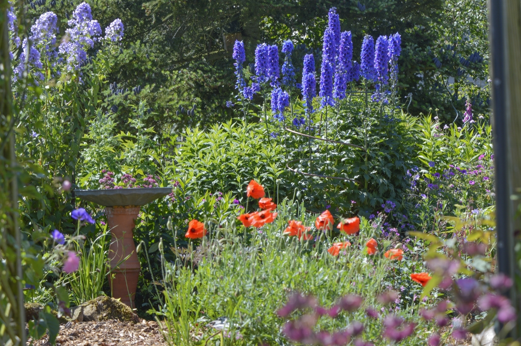 Organic garden in summer with garden ornament