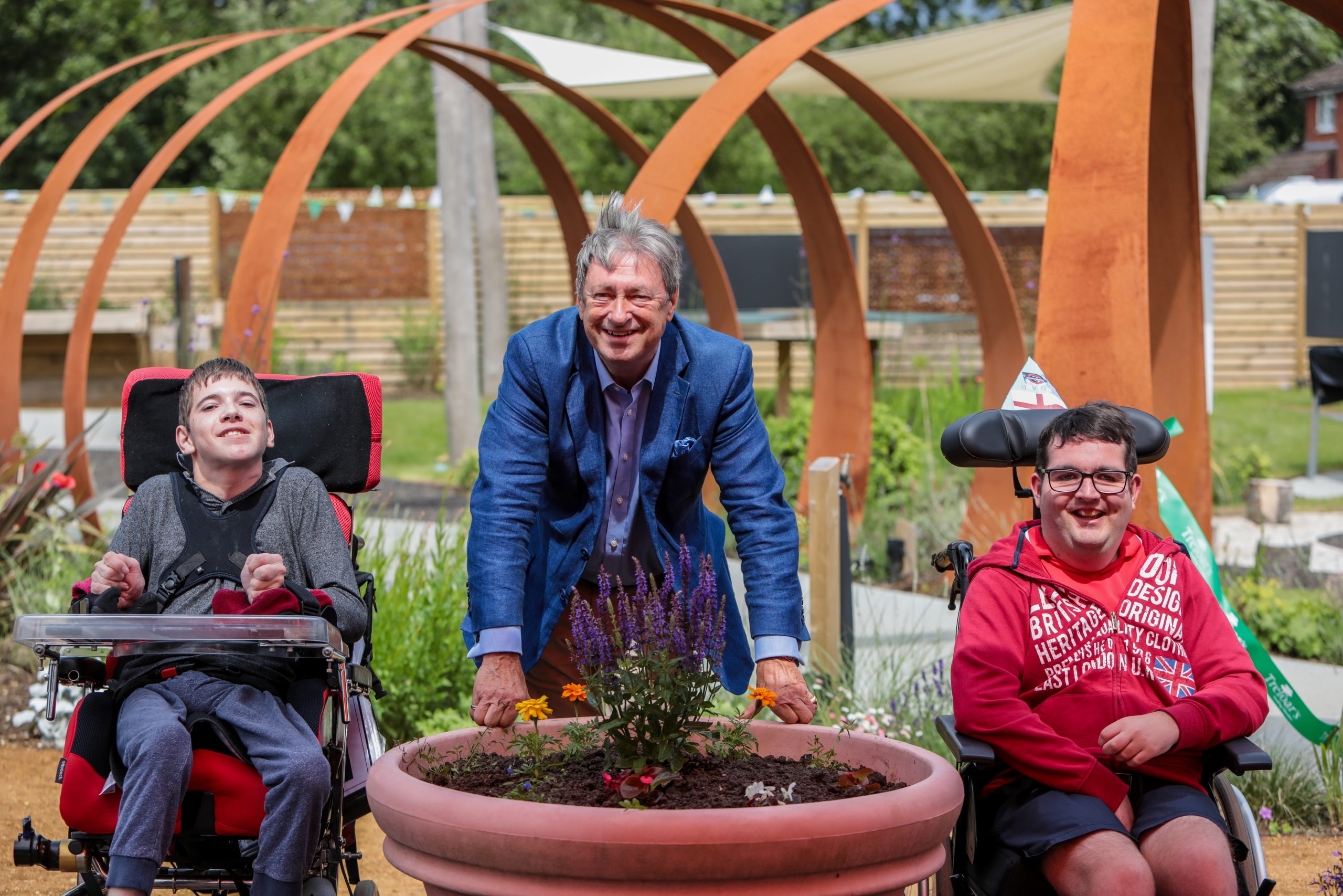 Alan Titchmarsh cuts the ribbon for the new Outdoor Learning Centre with students Harry and Joe © Treloar’s